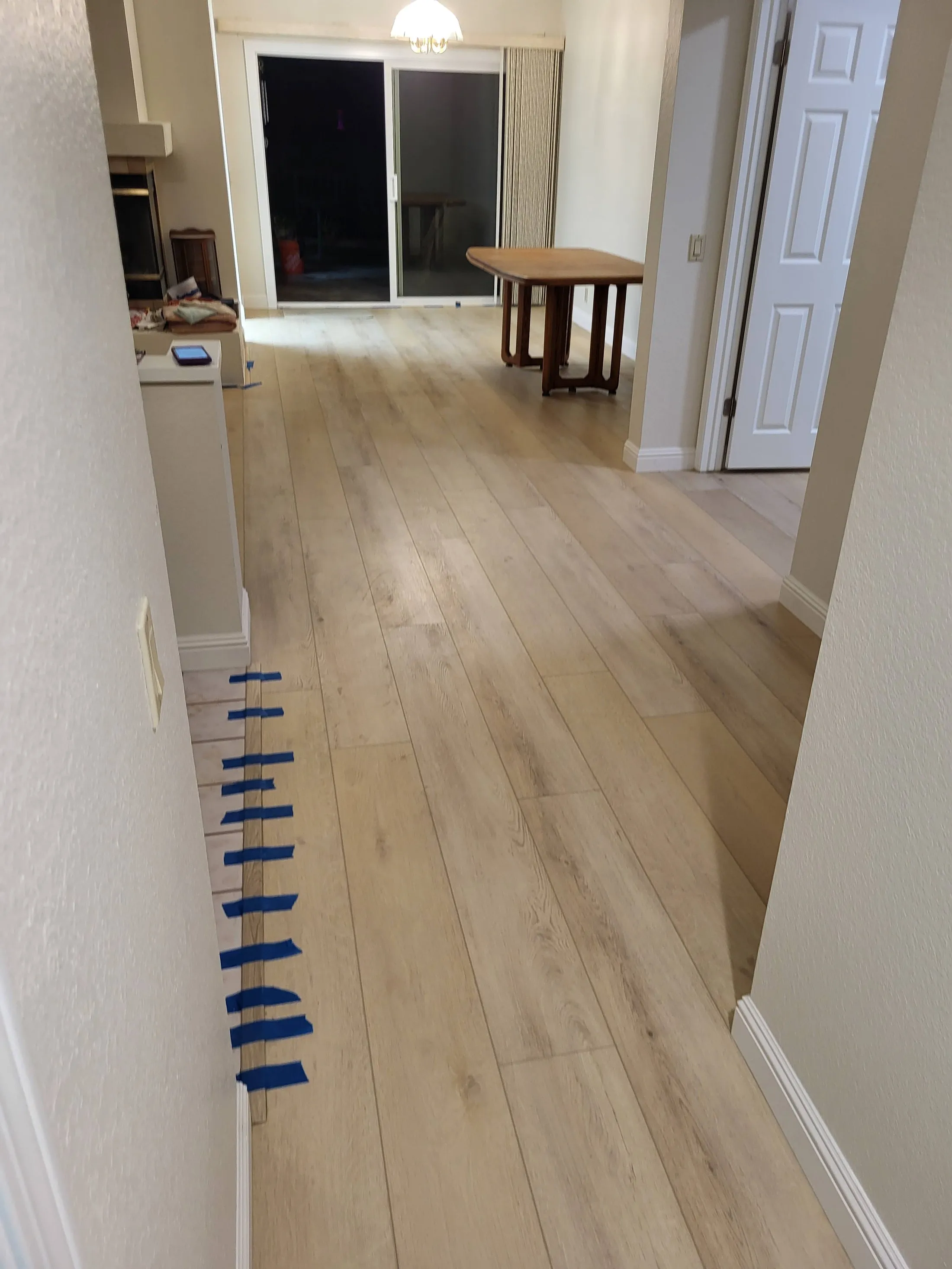 Protecting a new floor with tape during a multi-room install